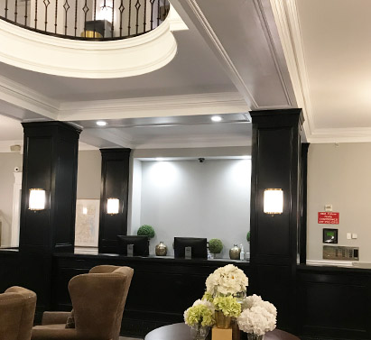 Dark stains and neutral-toned paint has been applied to the walls of a chic hotel lobby.